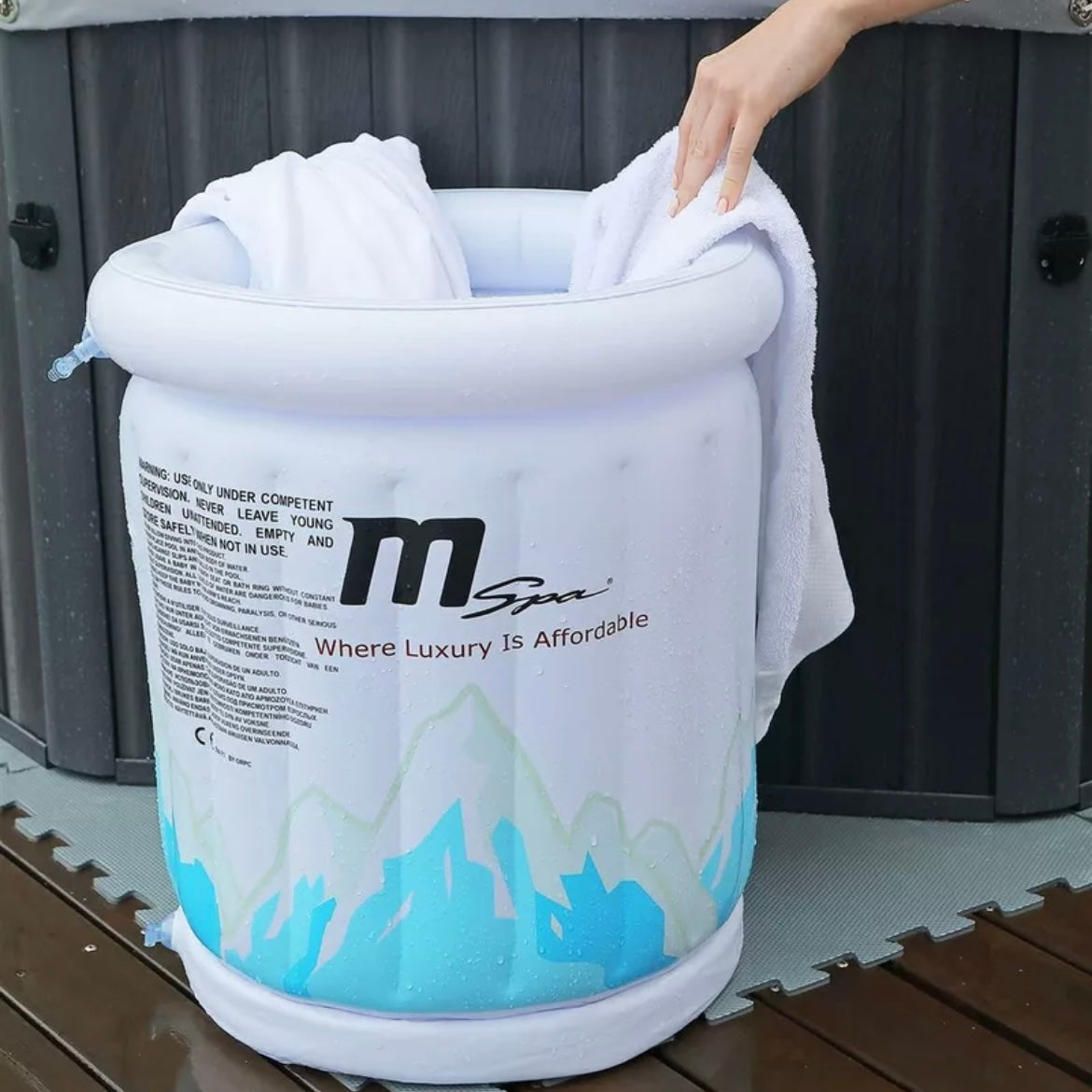 White inflatable bucket cooler with blue wave design and black MSpa logo, holding white towels on wooden deck. - Home Interior Shop - MSpa Inflatable Drinks Cooler & Towel Holder