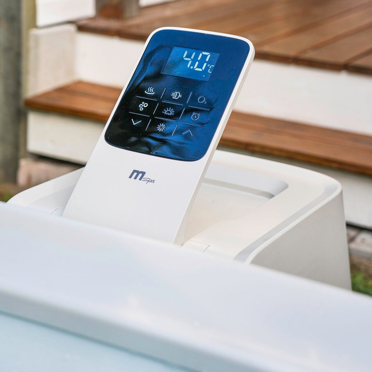 Digital control panel with blue backlit display showing temperature set at 40°C on white portable hot tub edge. - Home Interior Shop - MSpa Oslo 4-6 Person Portable Hard Frame Hot Tub - Amber