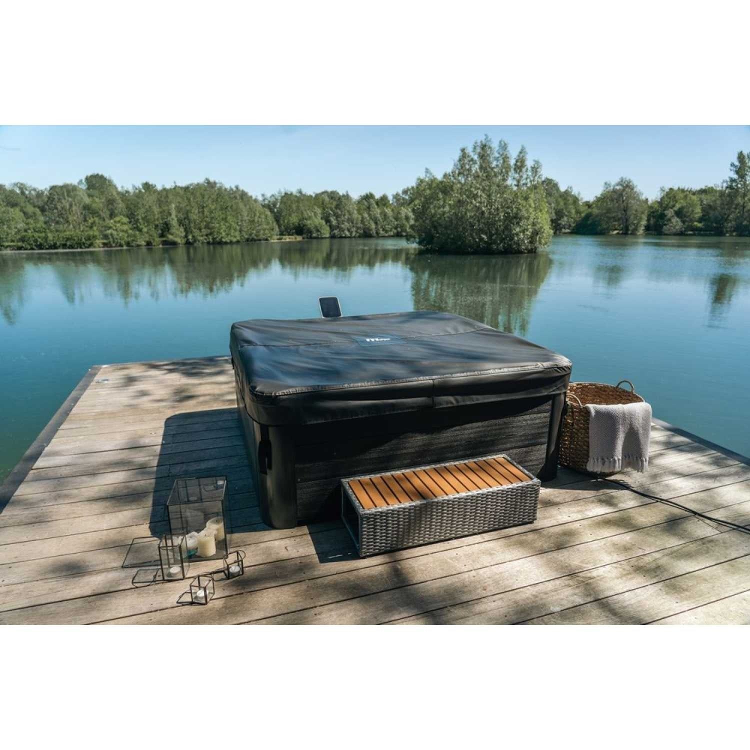 Grey square portable hard frame hot tub with cover on wooden dock by calm lake, surrounded by trees and sunlight. - Home Interior Shop - MSpa Oslo 4-6 Person Portable Hard Frame Hot Tub - Grey