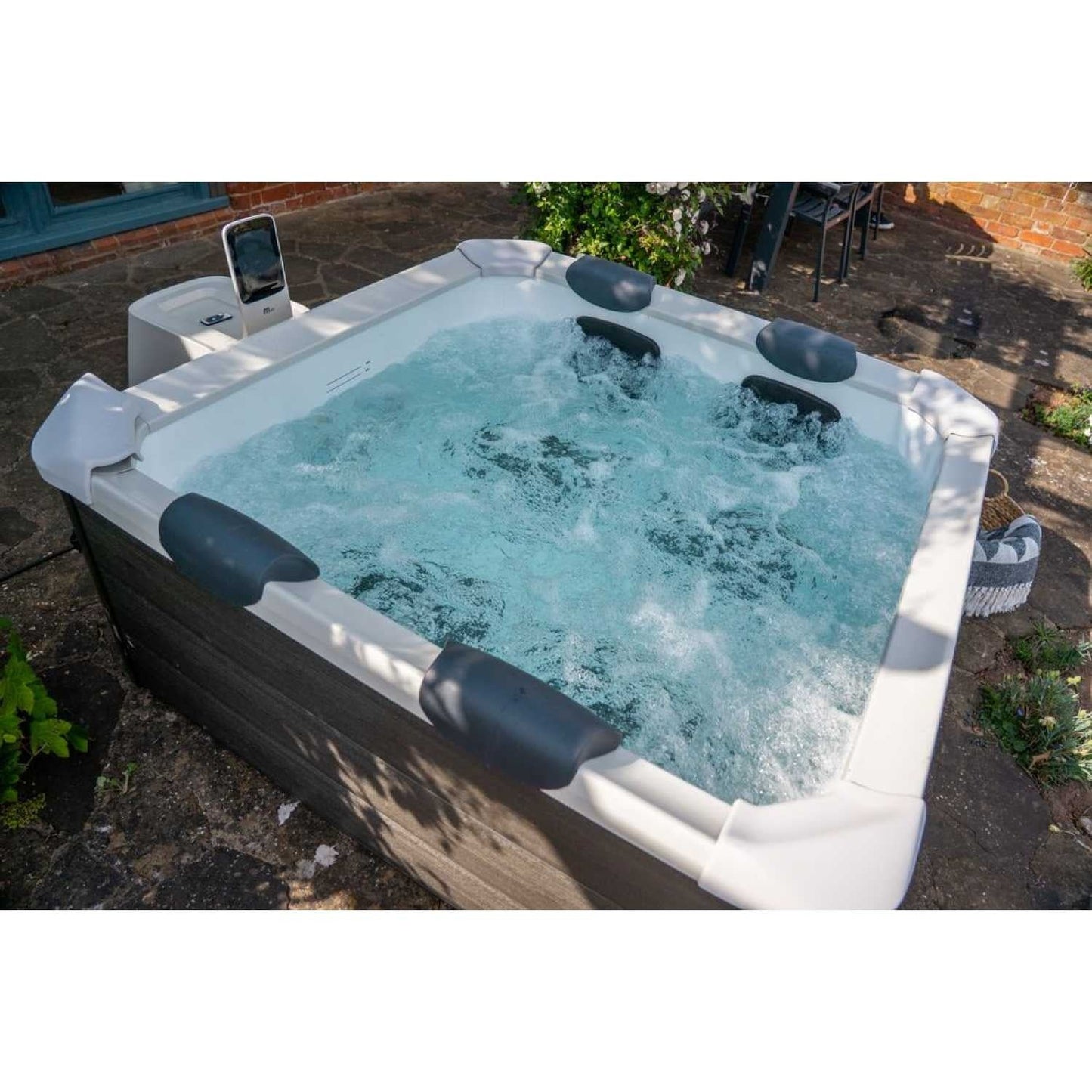 Grey square portable hot tub with hard frame, four black cushioned headrests, and bubbling water outdoors on stone patio. - Home Interior Shop - MSpa Oslo 4-6 Person Portable Hard Frame Hot Tub - Grey