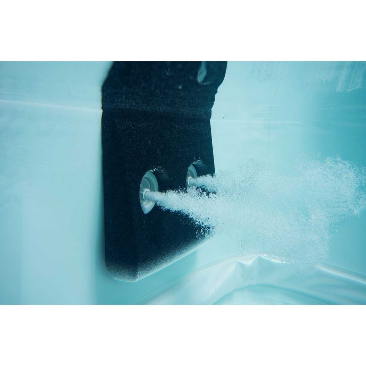 Close-up of grey MSpa Oslo Plus XL hot tub jet releasing bubbles into water against smooth inner tub wall. - Home Interior Shop - MSpa Oslo Plus XL Portable Hard Frame Hot Tub - Grey