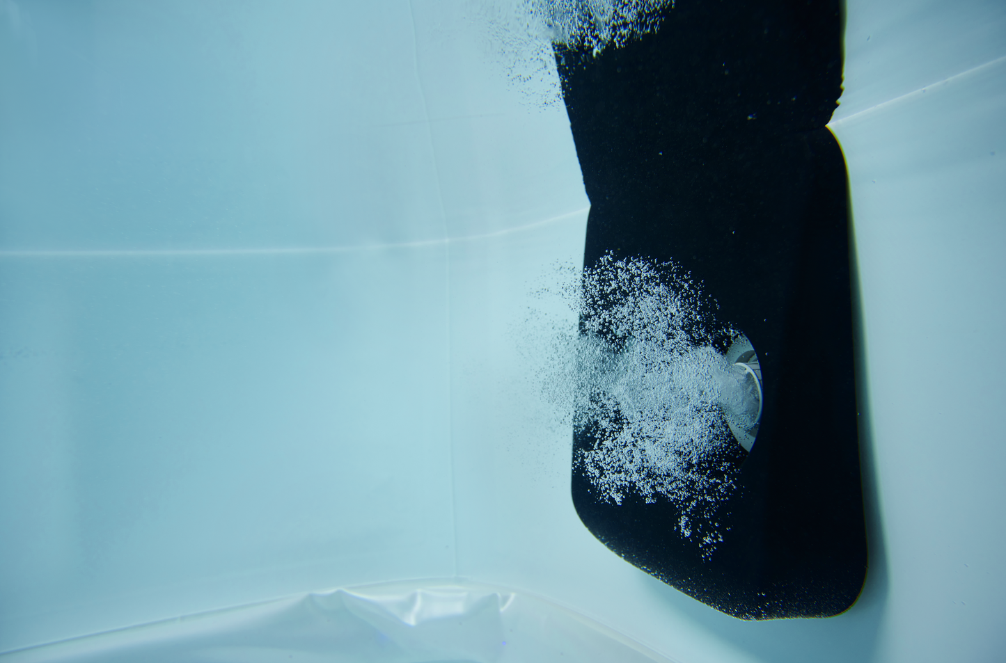 Black jet releasing bubbles inside amber MSpa Oslo portable hard frame hot tub filled with water. - Home Interior Shop - MSpa Oslo 4-6 Person Portable Hard Frame Hot Tub - Amber